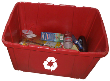 Rectangular recycling bin full of plastics and other items ready to be recycled.