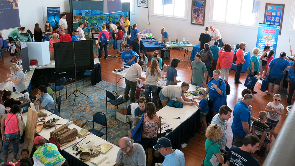 People visiting activity booths in the sanctuary ballroom