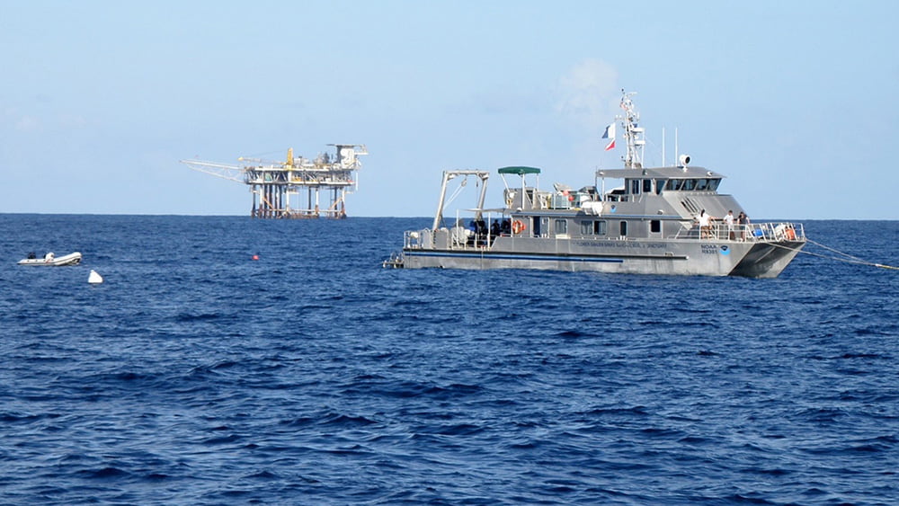 Sanctuary research vessel moored on a buoy with a gas platform in the distance